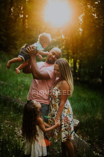 Vertical portrait of biracial family looking at each other — Stock Photo