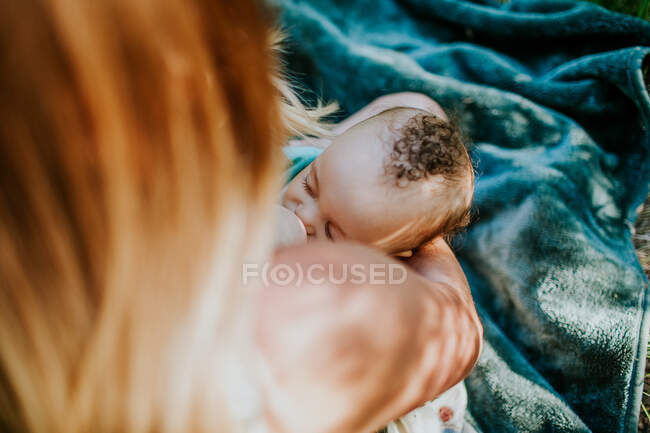 Overhead view of young infant boy breast feeding — Stock Photo