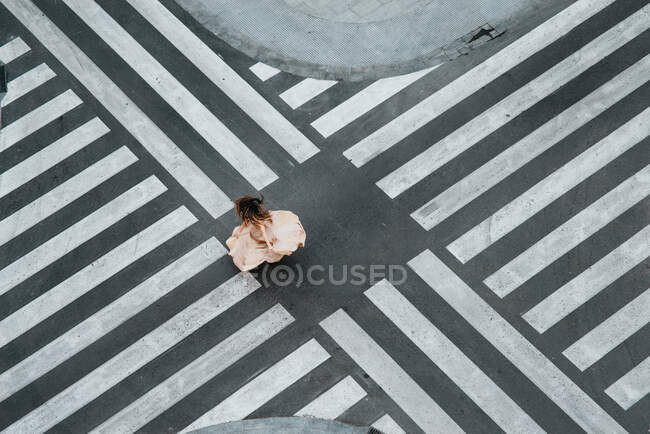 Woman dancing in a zebra crossing with a dress — Stock Photo