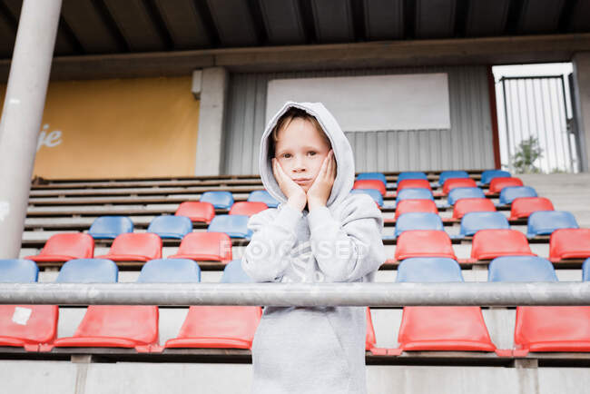 Boy looking out at a track looking nervous in sports clothes — Stock Photo