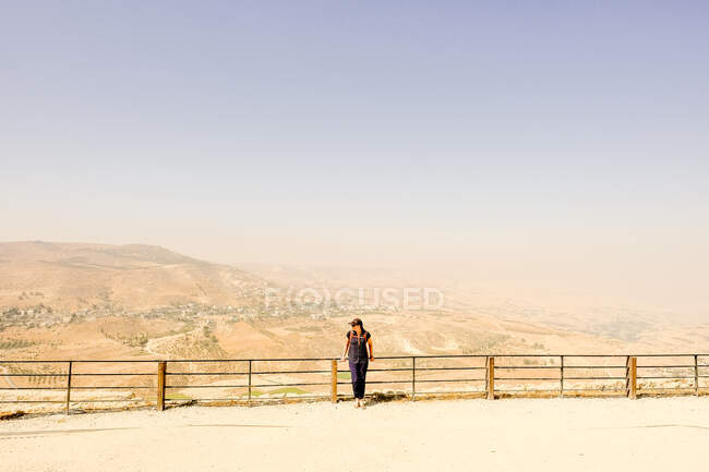 A woman stand along a railing at Kerak Castle, Jordan — Stock Photo