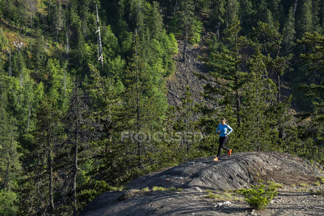 Female athlete running near mountains — Stock Photo