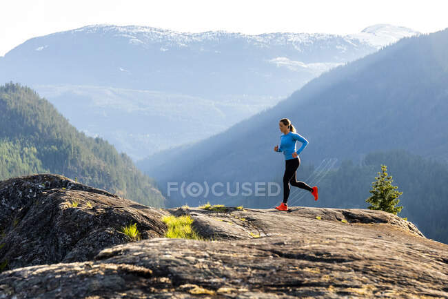 Спортсменка біжить на каменях у високогір'ї — стокове фото