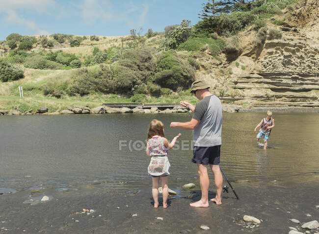 Family fishing at a scenic river spot — Stock Photo