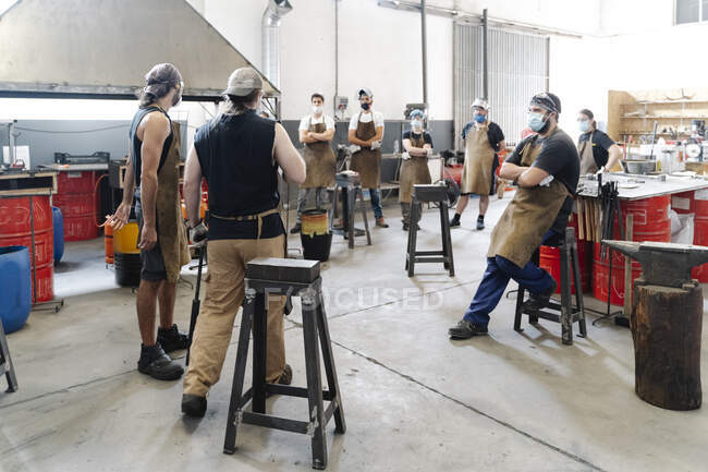 Company of blacksmiths in workshop — Stock Photo