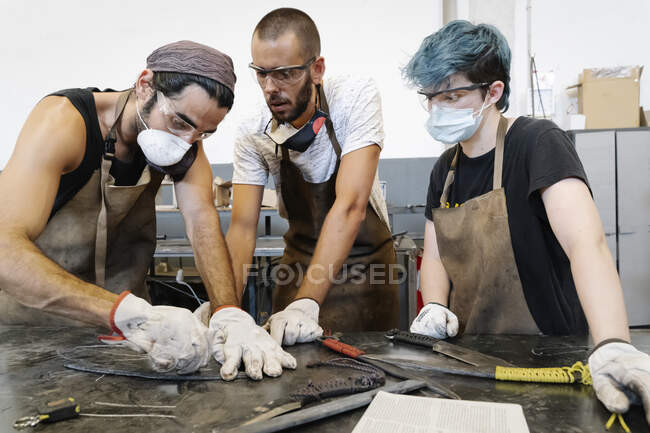 Craftsmen working in garage together — Stock Photo