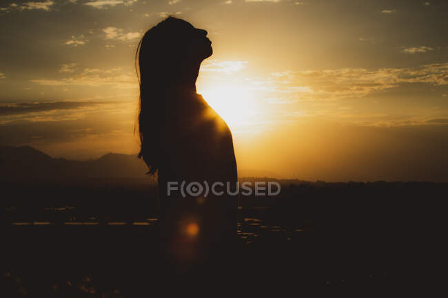 Side profile of woman at golden hour — Stock Photo