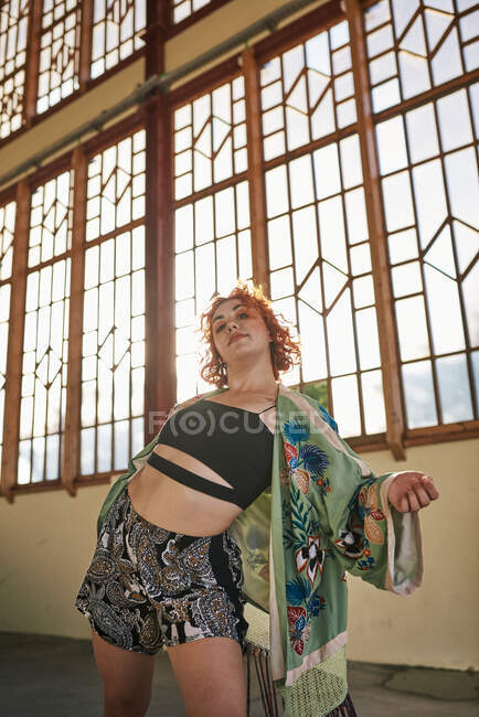 Young alternative redhead dancing in a green kimono — Stock Photo
