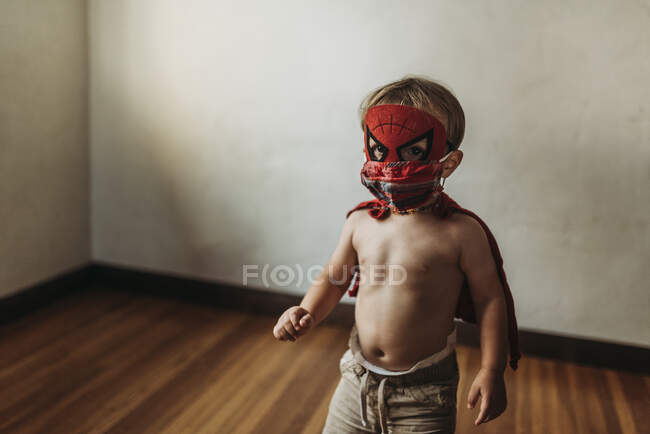 Toddler boy walking in Halloween costume and face mask — Stock Photo