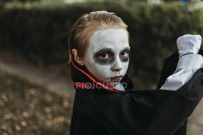 School aged boy dressed as Dracula posing in costume on Halloween — Stock Photo