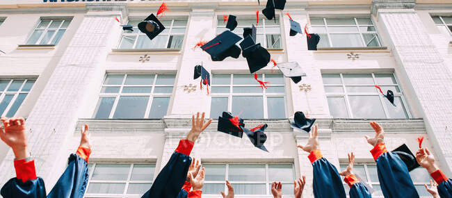 Graduation caps thrown in the air — Stock Photo