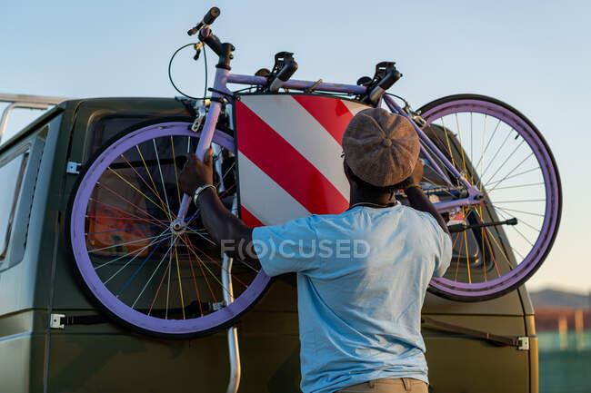 Hombre afroamericano con una bicicleta anticuada en su furgoneta - foto de stock