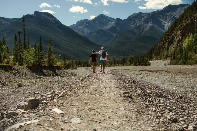 Father and son walking in the mountains — Stock Photo