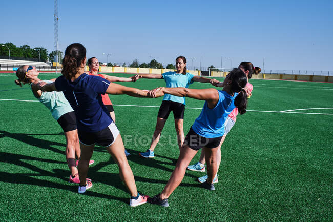 Group of young women practice stretching after their training — Stock Photo
