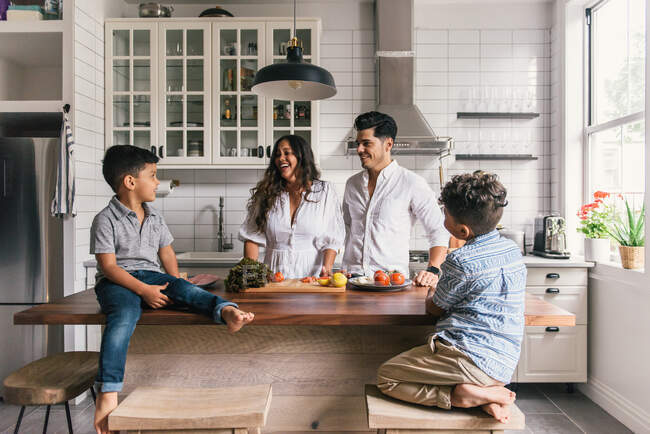 Young happy family spending time with kids — Stock Photo