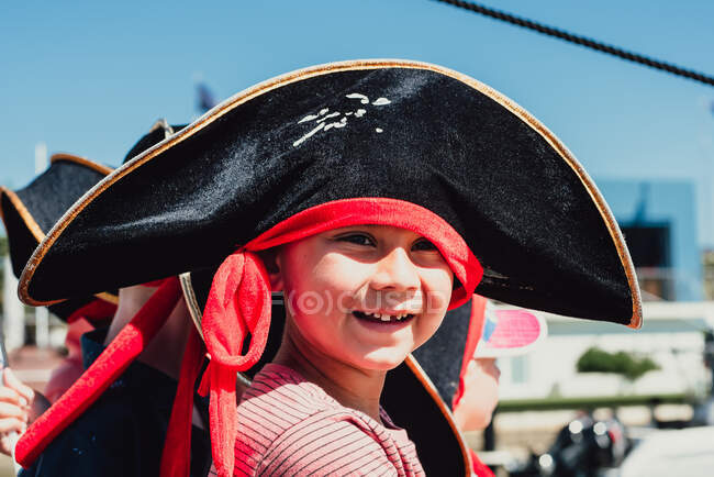 Close up portrait of 6 year multi racial boy in black pirate hat — Stock Photo