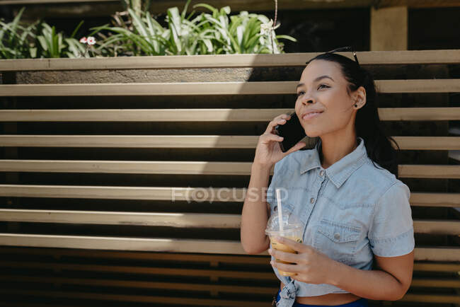 Portrait of cute hispanic girl talking on the phone — Stock Photo