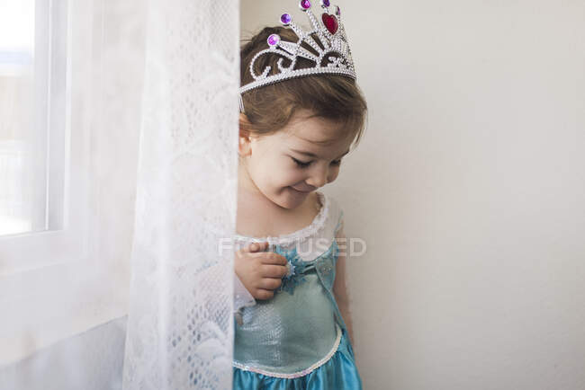 Smiling 4 yr old girl dressed in blue princess gown and crown — Stock Photo