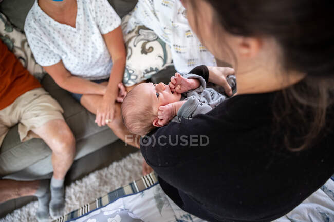 Beautiful newborn baby staring at his mother. — Stock Photo