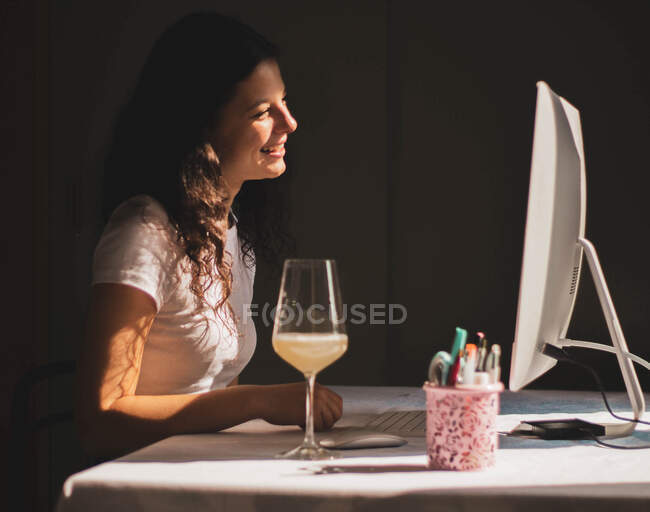 Girl talking on video call and toasting, celebrating — Stock Photo