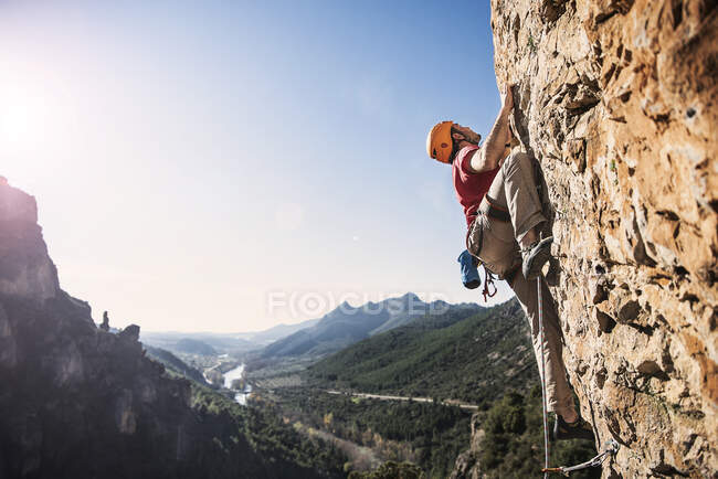 Un escalador con un paisaje al fondo - foto de stock