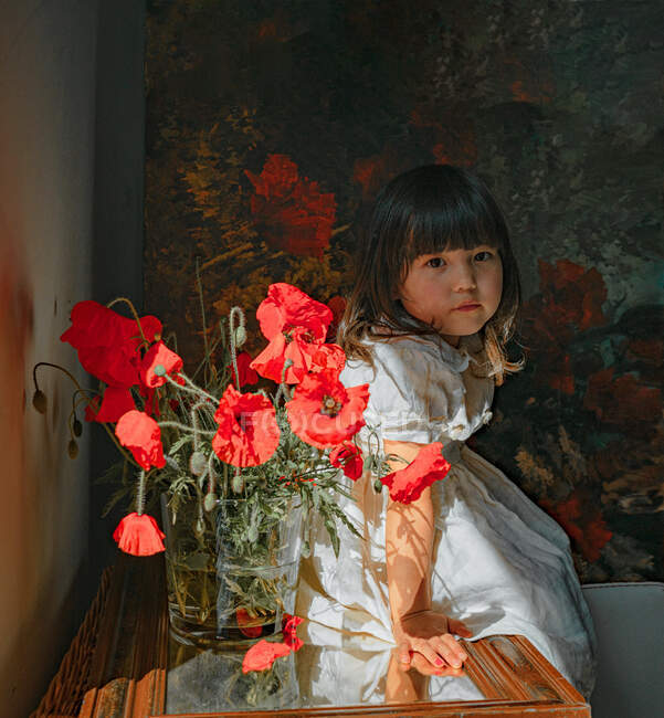 Portrait of girl red puppies flowers — Stock Photo