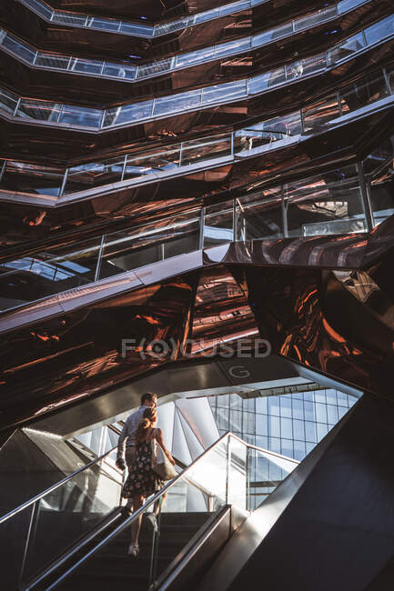 Пара прогулок в потрясающее здание с солнечным светом — стоковое фото
