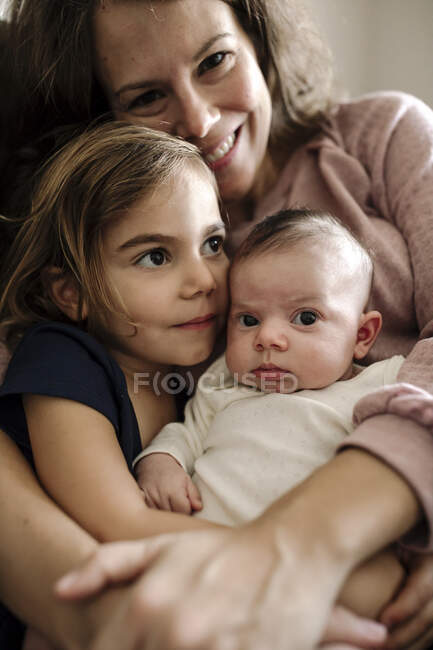 Happy mother and daughters at home — Stock Photo