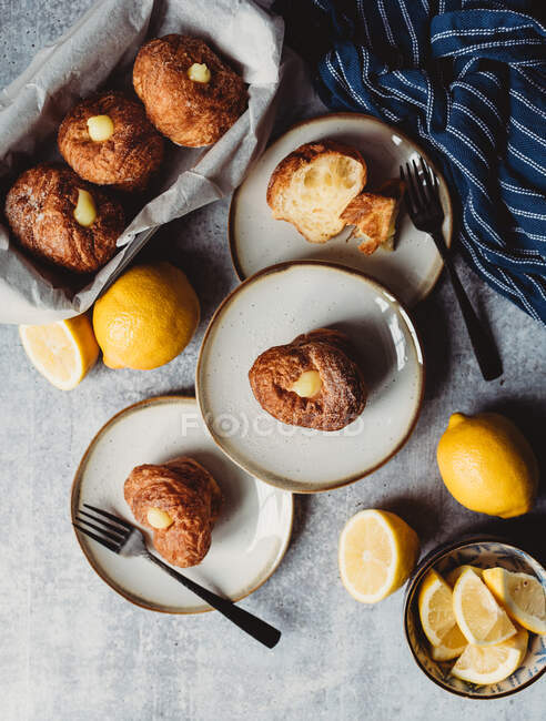 Close-up view of plated lemon filled cruffins on a stone counter — Stock Photo