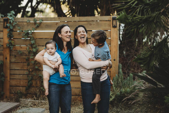 Two happy women with kids — Stock Photo