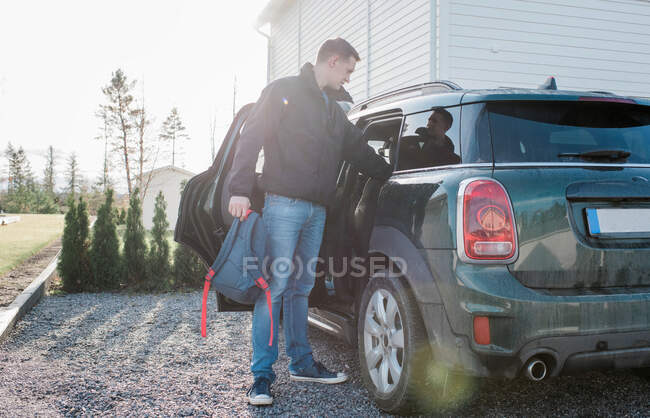Father putting the kids in the car before school — Stock Photo