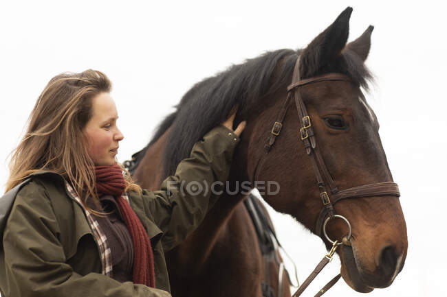 Young woman with a horse outside — Stock Photo