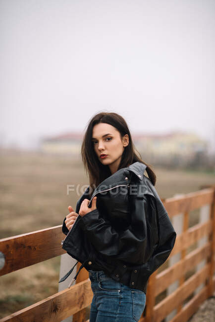 Porträt einer stilvollen Dame mit Lederrock-Jacke, die in die Kamera blickt — Stockfoto
