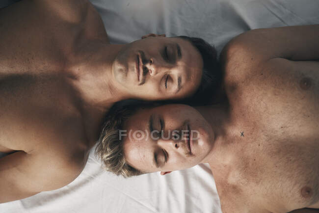Portrait of two boys with moustaches face to face with their eyes closed — Stock Photo
