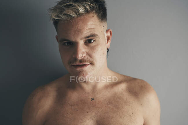 Portrait of a blond boy with a moustache and piercing — Stock Photo