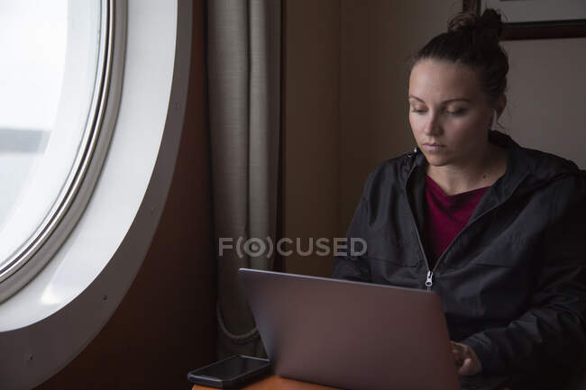 A female working remotely on a ship — Stock Photo