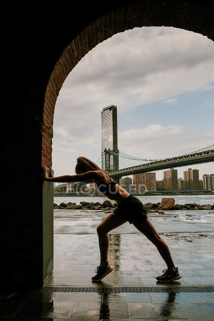 Silhouette of woman stretching against skyline — Stock Photo