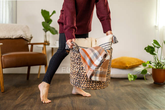 Woman carrying basket at home — Stock Photo