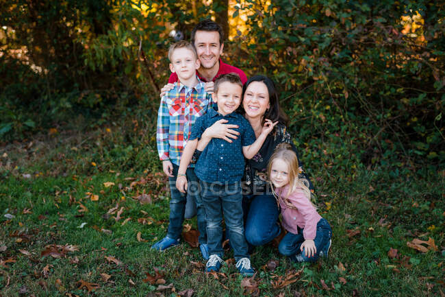 Family portrait with father, mother, sons, daughter outdoors in nature — Stock Photo