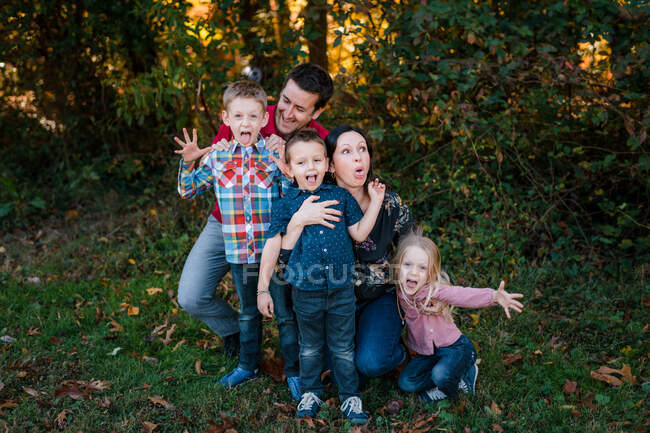 Family portrait with mom, dad, brother, sister making silly faces — Stock Photo