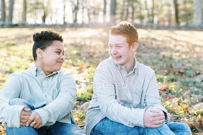 Two friends on forest and autumn leaves background — Stock Photo