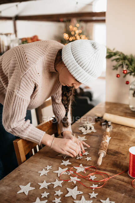 Young woman making clay star ornaments for Christmas tree — Stock Photo