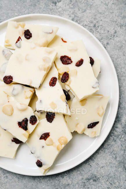 Homemade white plate with delicious cheese and nuts on a wooden background — Stock Photo