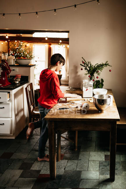 Kind backt Weihnachtsplätzchen in der Küche — Stockfoto