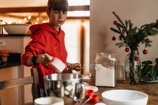 Child making  cookie dough for Christmas cookies — Stock Photo