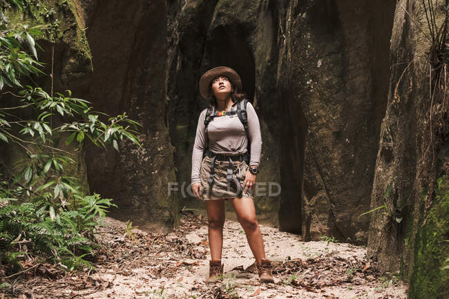 Woman looking up in a canyon with sunlight in front. — Stock Photo