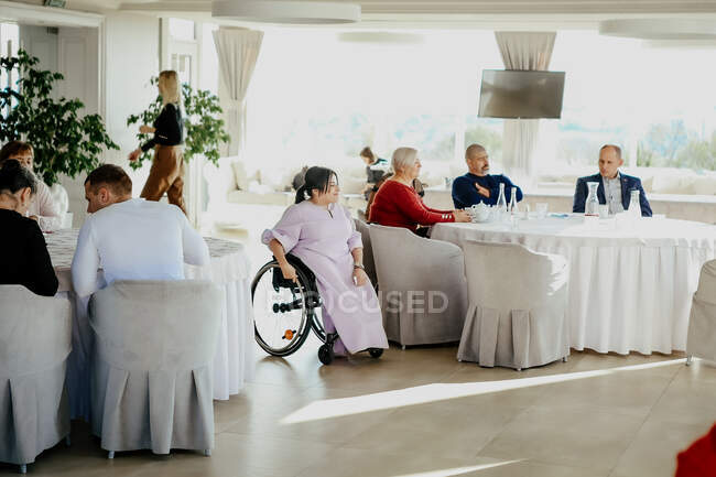Mujer en silla de ruedas en una conferencia inclusiva - foto de stock