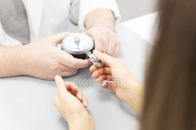 Doctor checking grip strength for patient — Stock Photo