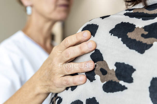 Cropped shot of mature female doctor touching her patient to give support — Stock Photo