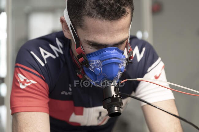 Close-up shot of sportsman in protective mask working out for heath examination — Stock Photo
